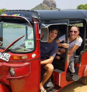 two people sitting inside of a small bus
