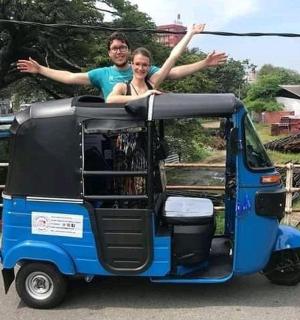 a man and woman are sitting on top of a small vehicle