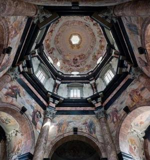 a building with paintings on the ceilings and windows