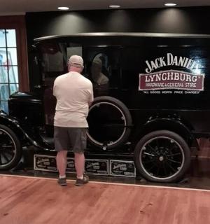 a man is looking at an old black car