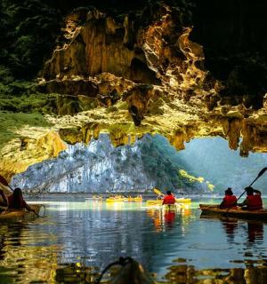 a group of people in kayaks in a cave
