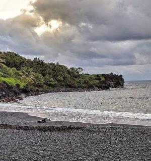 a beach with a rocky shoreline and the ocean