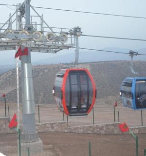 two blue and red cable cars on a mountain