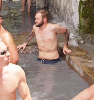 a group of men standing in the water