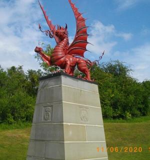 a statue of a dragon on top of a monument