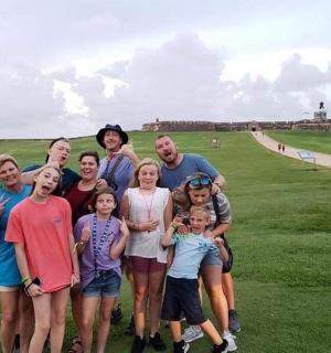 a group of people posing for a picture on a golf course