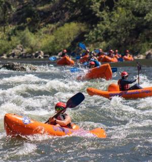 a group of people in kayaks on a river