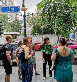 a group of people standing on a street corner