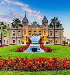 a building with a large flower garden in front of it