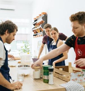 a group of people in a kitchen preparing food