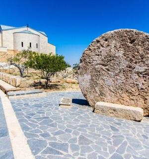 a large rock sitting in front of a building