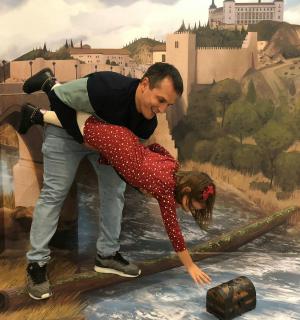 a man and a woman standing on top of a painting