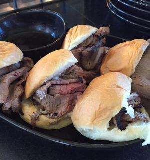 桌子上放着一盘四块手撕猪肉三明治