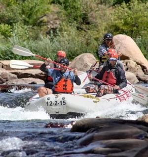 a group of people in a raft on a river