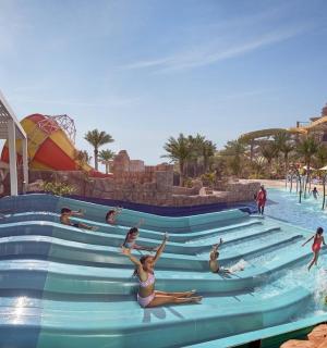 a group of people in a pool at a water park
