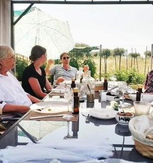 a group of people sitting around a long table