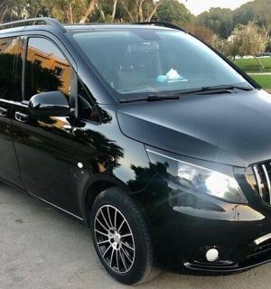 a black limo car parked in a parking lot