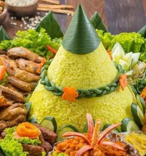 a plate of food with a pineapple with a party hat