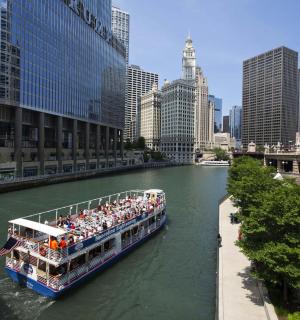 a tour boat on a river in a city