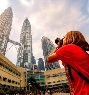 a woman taking a picture of the city with a camera
