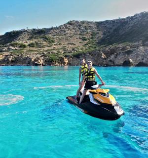 două persoane pe un jet ski în apă