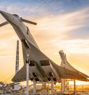 a fighter jet sitting on display at an airport