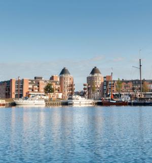 a marina with boats in the water and buildings
