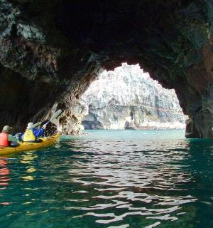 a group of people in a kayak in a cave