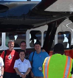 a group of people standing in front of a plane