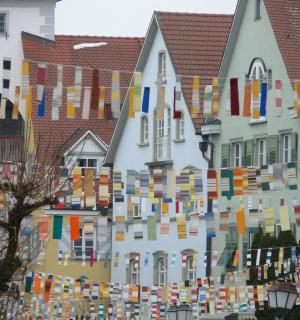 a row of houses with colorful flags hanging from them