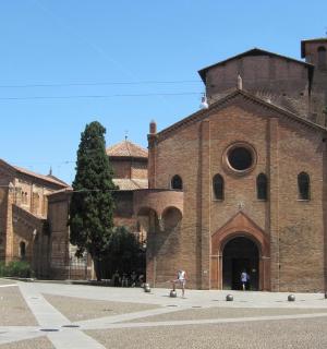 a large brick building with people walking in front of it