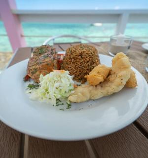 a plate of food on a table with the ocean in the background