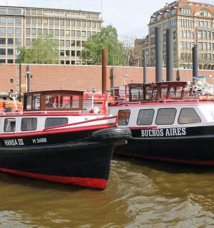 two boats are docked next to each other in the water