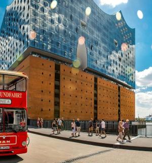 a red double decker bus on a city street