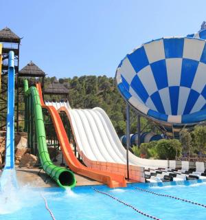 a water park with a water slide and a roller coaster