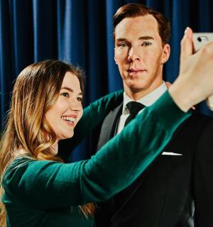 a woman taking a picture of a man taking a picture