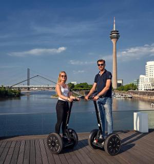 a man and a woman riding on segifts on a pier