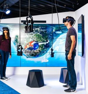 a man and a woman standing in front of a exhibit