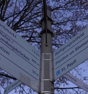 a street sign with many signs on a pole