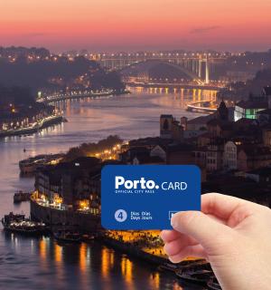 a hand holding a card with a view of a river
