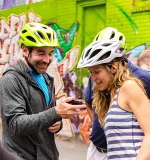 一名戴着头盔的男子和一名戴着头盔的女子正在看手机