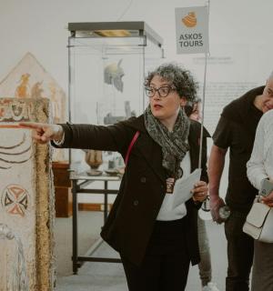 a woman pointing at a painting in a museum