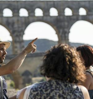 a group of people standing in front of a bridge