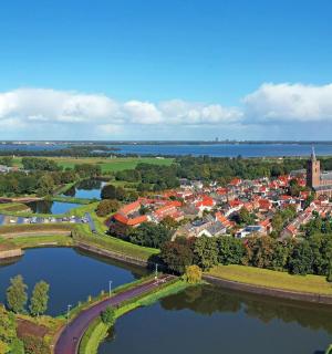 an aerial view of a town next to a river