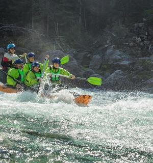 a group of people in a raft in a river