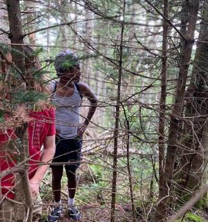 a group of people standing in the woods