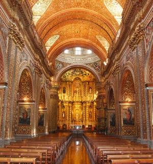 a large church with a large altar and pews