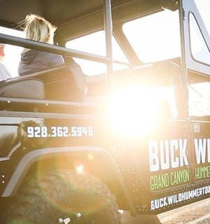 a group of people riding in a jeep on the road