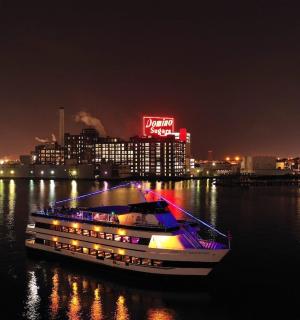 a boat in the water with a city at night