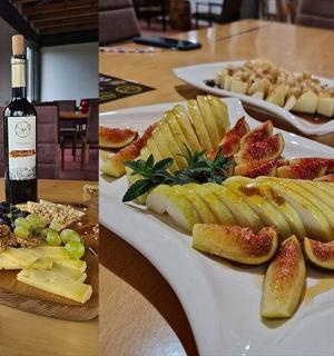 a table with two plates of food and a glass of wine